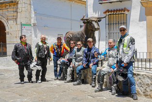 Bikers in front of the monument to a bullfighting arena in Extremadura